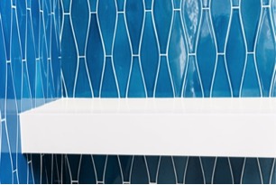Shower shelf in blue tiled shower in New Jersey custom built home